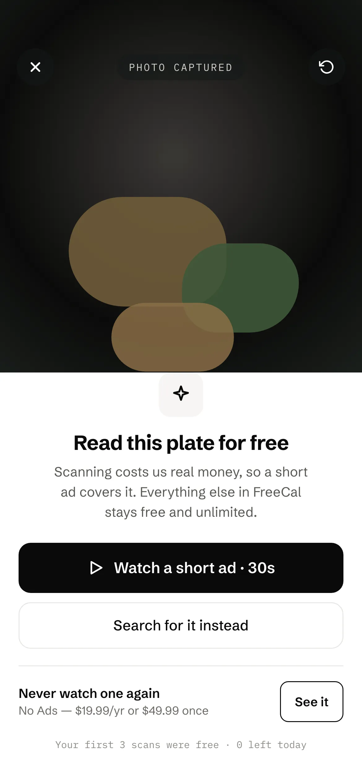 The photo scan gate: read this plate for free, with the option to watch a short ad or search instead.